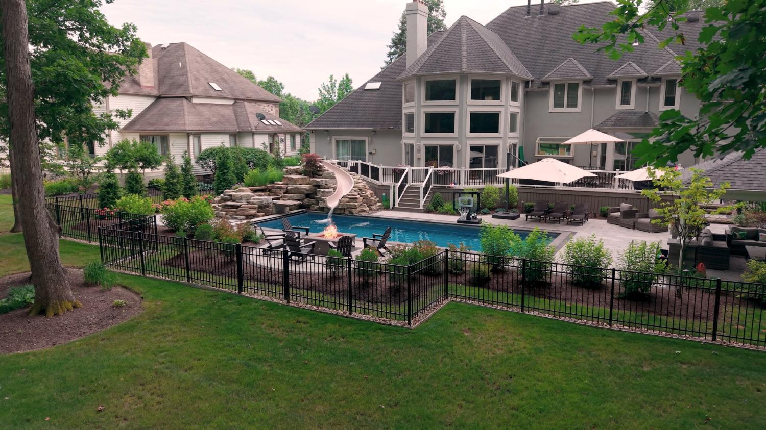 Backyard pool with integrated slide and waterfall feature in Ohio