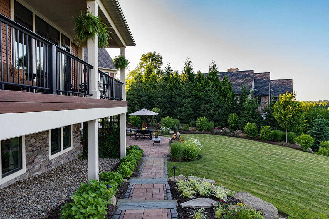 Cozy stone fire pit with lakeside views in a luxury outdoor living space in Novelty, OH