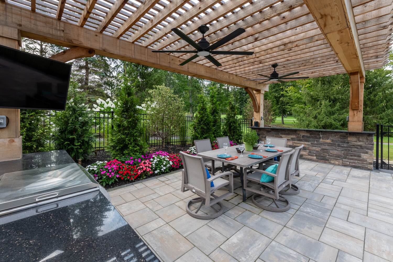 Elegant wooden pergola with an outdoor kitchen and dining space in Painesville, OH