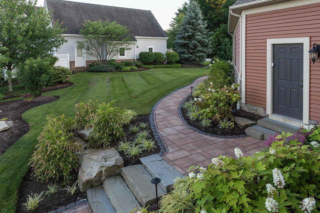Expertly crafted stone walkways and patios complementing a lakeside home in Cleveland, OH