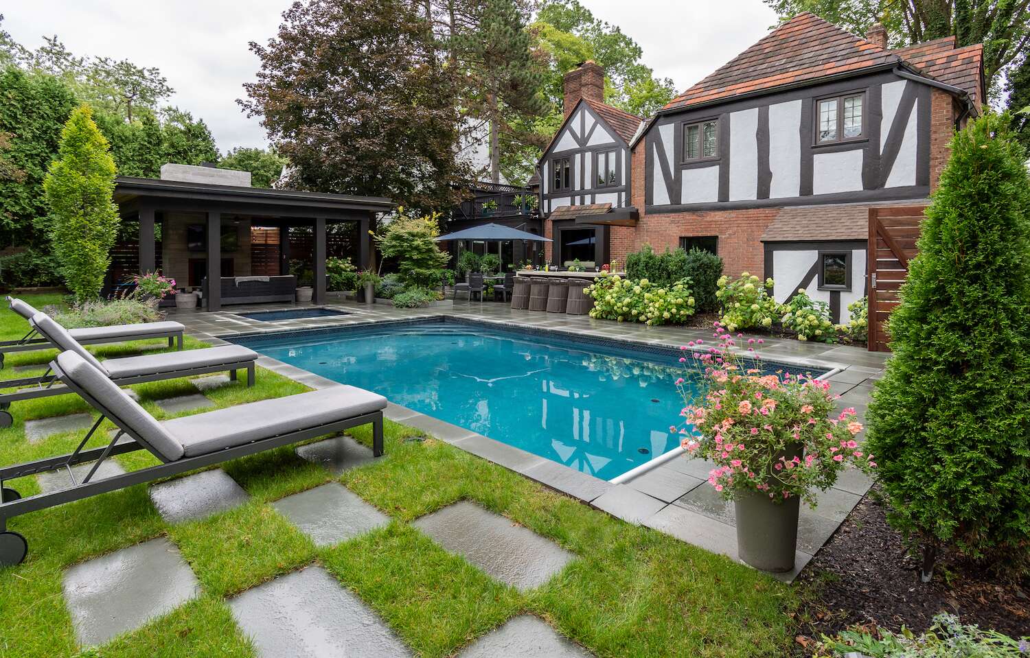 Fully equipped outdoor kitchen with stainless steel appliances and a stone bar in Bainbridge, OH