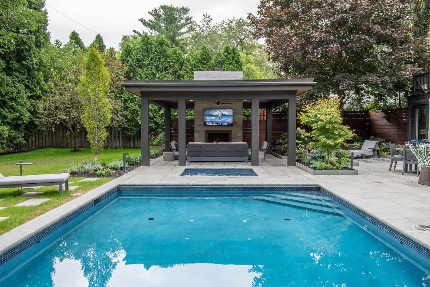 Resort-style swimming pool in Solon, OH with built-in lounge areas for relaxation