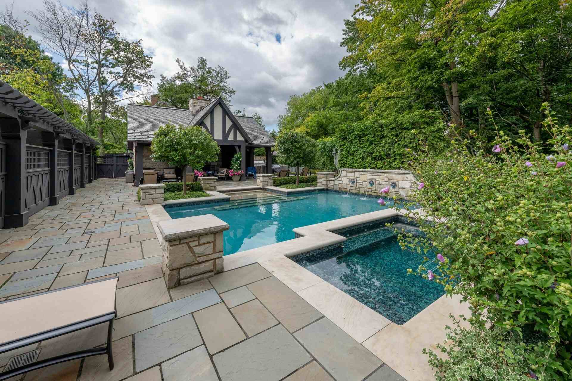 Stunning backyard pool and spa with elegant stonework at a private residence in Pepper Pike, OH Stunning backyard pool and spa with elegant stonework at a private residence in Pepper Pike, OH