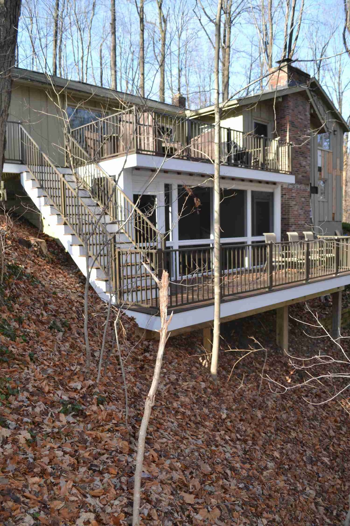 Stylish outdoor living deck connected to home in Gates Mills, OH