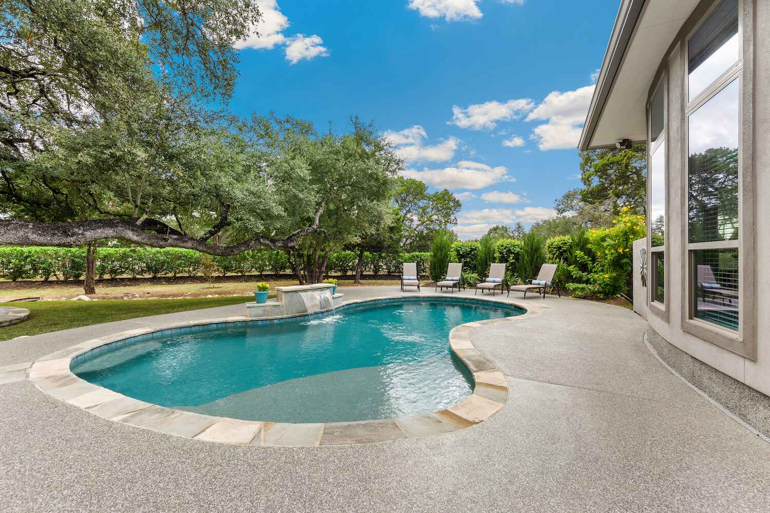 Luxury pool with built-in tanning ledge for sunbathing and relaxation in Chagrin Falls, OH