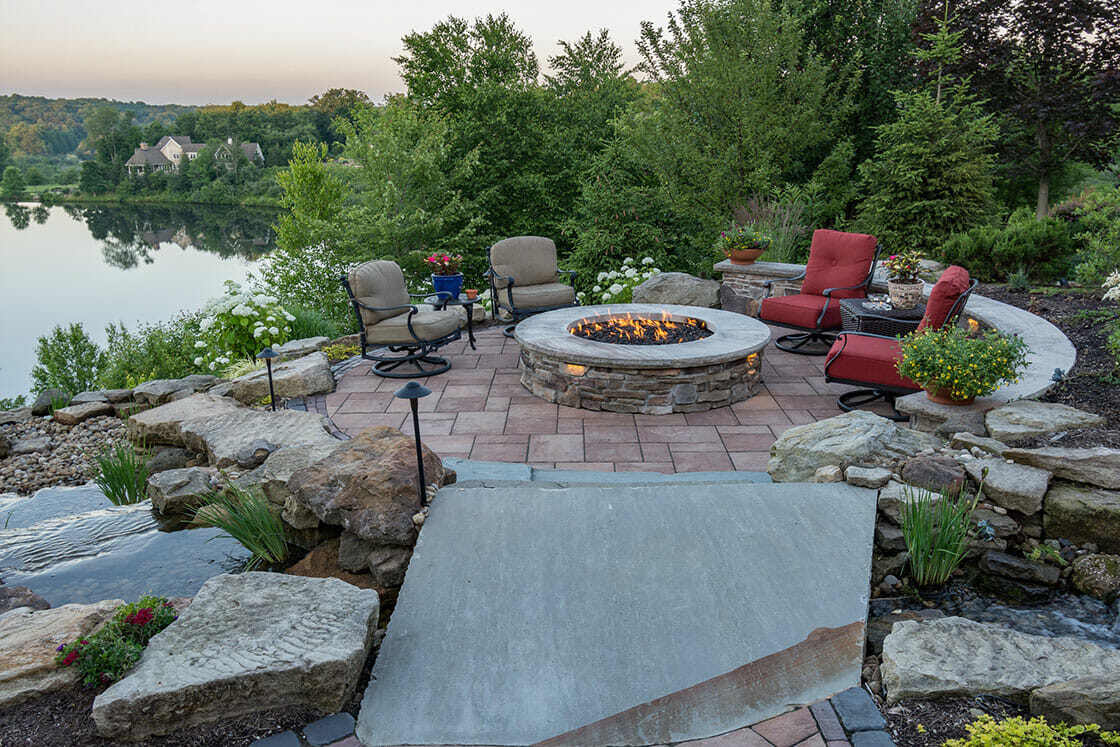 Relaxing outdoor seating space with lake views in a beautifully designed backyard in Painesville, OH