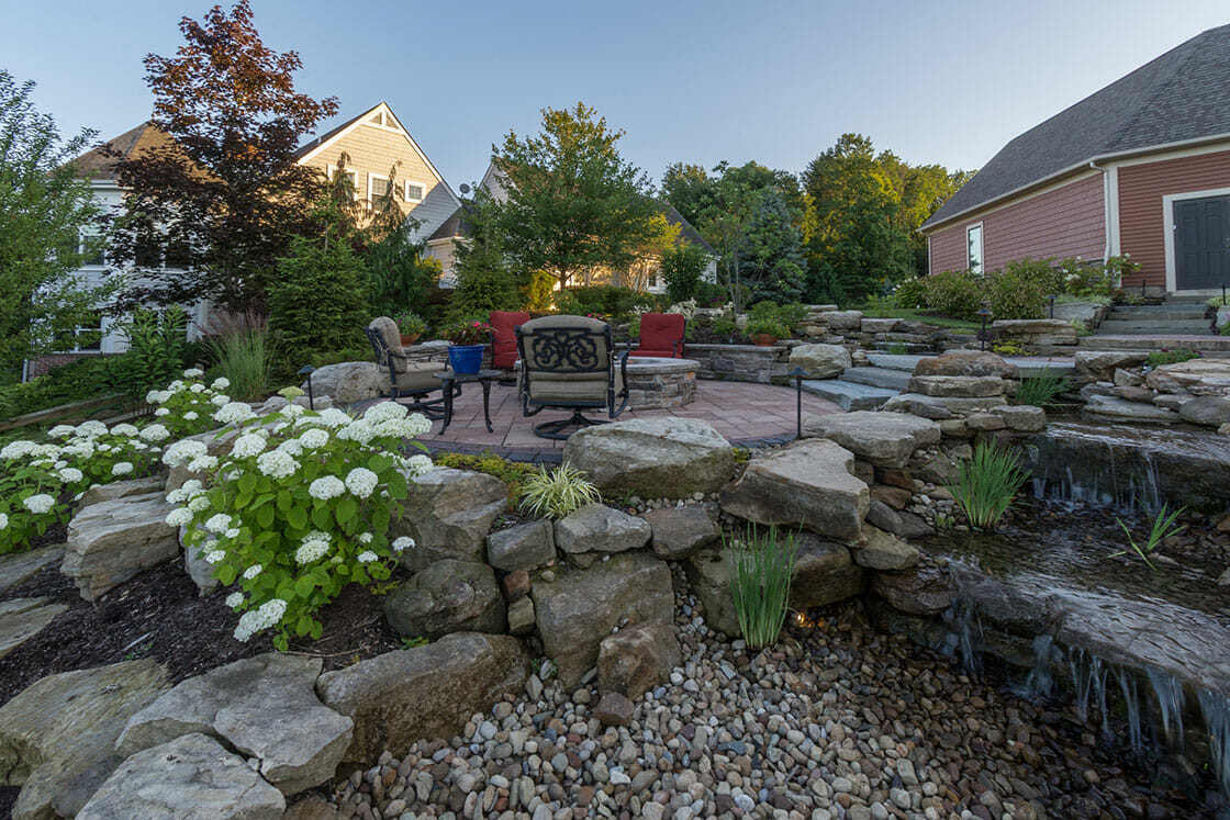 Spacious outdoor dining patio with elegant furniture overlooking the water in Auburn Township, OH Spacious outdoor dining patio with elegant furniture overlooking the water in Auburn Township, OH