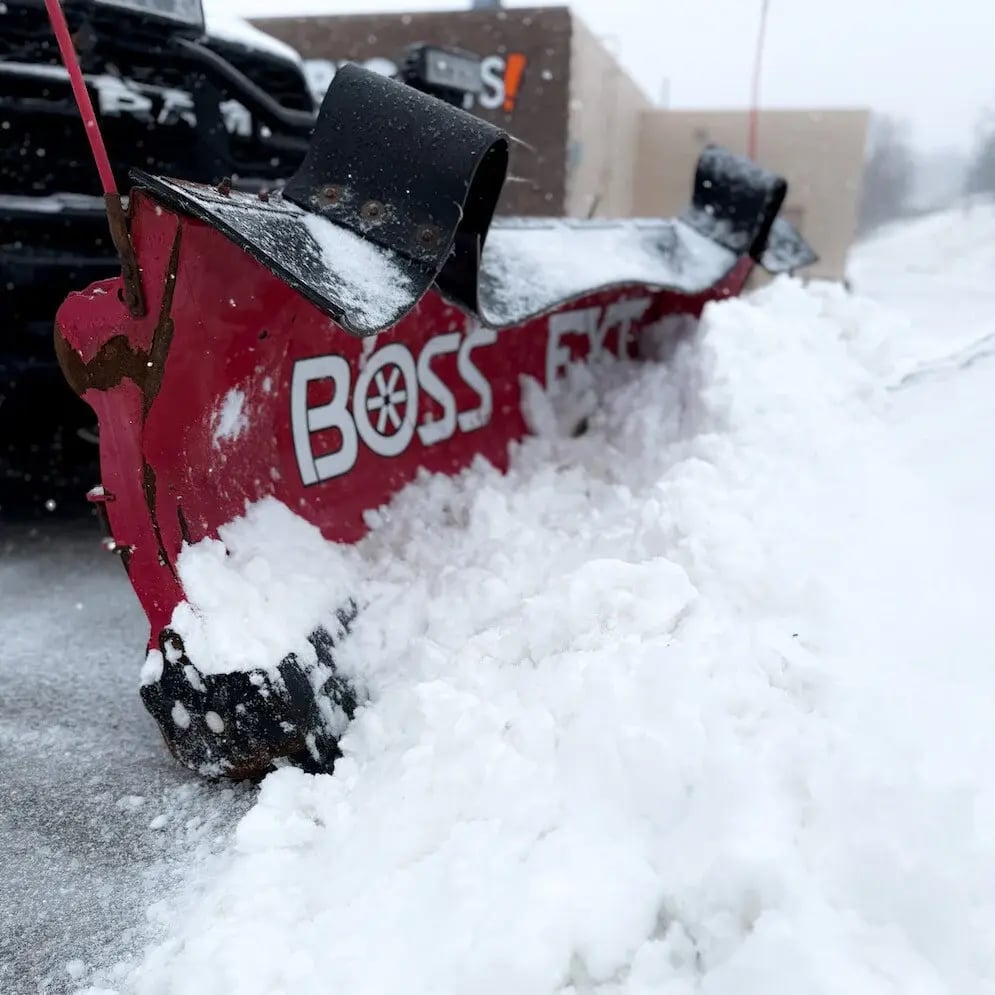 Truck with snow plow attachment servicing a commercial property at sunrise in Aurora, OH-2